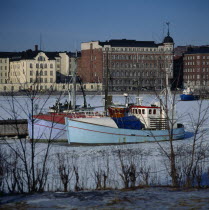 North Harbour fishing boats frozen sea buildings beyond