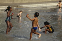 Kids playing Clapham paddling pool.