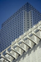 Canary Wharf. Canada Tower rising over white building in the foreground