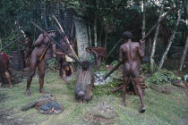 Dani Tribesmen building a traditional oven with hot stones