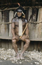Dani Warrior man wearing a penis gourd with the top made from the tail of Cuscus animal