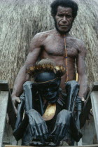Jiwika Village. Dani Warrior man holding smoked ancestral mummy of Chief Weraper Elosarek.