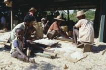 A group of men women and children Quartz cutting and sorting