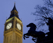 Westminster.Big Ben Clock Tower and the statue of Boudicea in silhouette in the foreground seen in evening light
