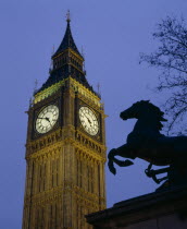 Westminster. Big Ben Clock Tower and the statue of Boudicea in silhouette in the foreground seen in evening light  Westminster