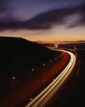 M62 Motorway. Elevated view over traffic in motion blur with light trails seen in late evening with a dramatic cloud formation