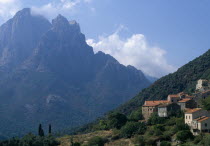 The cusp shaped summit of Capo D Orto provides a dramatic backdrop to the hillside village of Ota