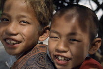 Portrait of smiling novice monk and temple boy on Lake Taungthaman near Mandalay.Burma Myanmar