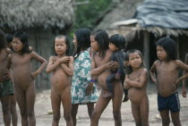 Xikrin children with strips of shaved hair and one small child with body painted with black genipapo dye. Brasil Kaiapo Kayapo Brazil Mebengorke