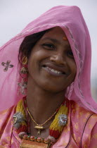 Portrait of smiling Desert woman wearing pink in Bhansda Village.