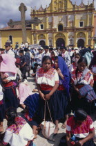 Zapatista demonstration with indigenous indian people gathered outside yellow building