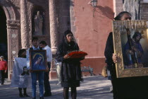 Oratorio de San Felipe Neri.  Good Friday Procession with men and women carrying religious images and representation of the crown of thorns.