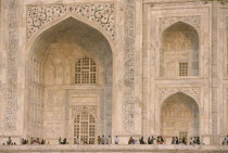 The Taj Mahal  detail of patterned marble walls with visitors below.