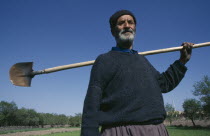 Portrait of farmer carrying spade over his shoulder Farming