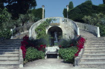 Musee Ile de France garden with steps surrounding a bench next to flowers and a statue Founded by Madam Ephrussi Rothschild