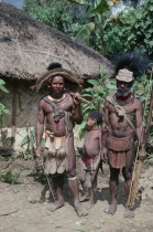 Southern Highlands.Tari. Huli tribemen with a child holding cane