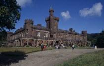 Kinloch Castle exterior with visitors in grounds. Built in 1901 as a shooting lodge and is currently a hotel.