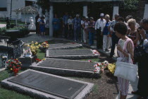 Graceland. Home of  Elvis Presley. Visitors at the graves of members of the Presley family