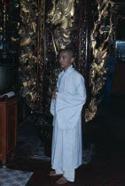 Monk wearing white robes in Vinh Trang Pagoda