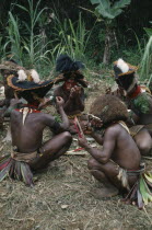 Southern Highlands.Tari. Huli Tribemen painting faces for Sing Sing Festival.