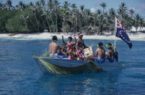 Manihiki Island. People traveling on boat welcoming visitors