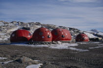 Red capsule fibreglass accommodation for remote field camps which can be transported by helicopter