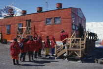 Tourists wearing red jackets visiting Chilean station Gonzalez Videla