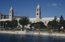 Clocktower Mall formally the offices of the Royal Naval Dockyard seen from across water with trees along the banks