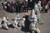 Taoist funeral with close relatives wearing white shrouds for mourning.