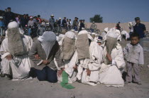 Taoist funeral with close relatives wearing white shrouds for mourning.
