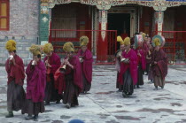 Tibetan Yellow Hat Buddhists playing horns  drums and cymbals during ceremony. Monastery of Lamas