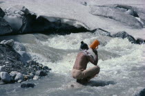 Sadhu pilgrim bathing at Gaumukh or the cow s mouth  sacred source of the River Ganges.GormukhGormuich