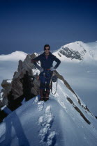 Climber on snow covered summit.mountaineering
