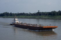 Barge on the Amazon River being pushed upstream towards Manaus.