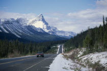 Car on Trans-Canada highway through snow covered landscape.  Automobile