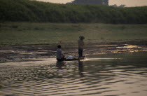 Fishermen in canoe throwing out net.Brasil Brazil