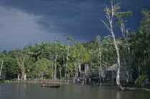 View toward riverside Cabloclo settlement with dark storm clouds overheadBrasil Brazil