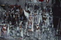 Carnival float carrying dancers wearing white beaded costumesBrasil