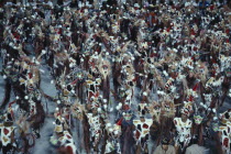 Carnival procession of dancers dressed in feathered costumesBrasil