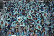 Carnival procession of dancers dressed in feathered costumesBrasil