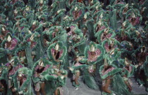 Carnival procession of dancers dressed in green feathered costumesBrasil