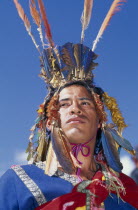 Male figure in traditional costume and feathered headress at Inti Raymi.  Head and shoulders shot.Cuzco  Cuzco