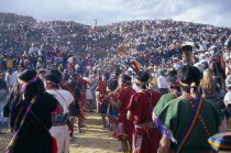 Parade of musicians at Inti Raymi watched by crowds on the surrounding hillside. Cuzco  Cuzco