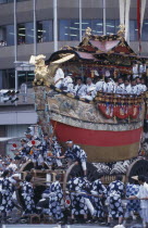 Gion festival float being pulled along the street
