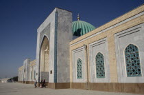 Al Bukhari Mausoleum. Exterior view along the facade with people at the entrance archway