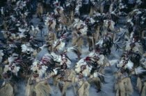 Carnival procession with dancers wearing glittering feathered costumes Brasil