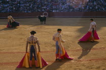 Matador in the Arenal bullring standing in front of the bull with three assistants in the foreground
