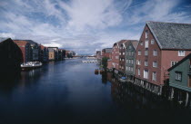 Wharf area. Traditional wooden waterfront buildings with bridge in the distance and moored boats