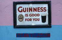 Dan Foleys pub sign saying Guinness is Good for You  with the words Its an Illusion painted on the wall underneath Republic of Ireland Eire