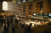 Grand Central station ticket hall at rush hour with light streaming through the windows